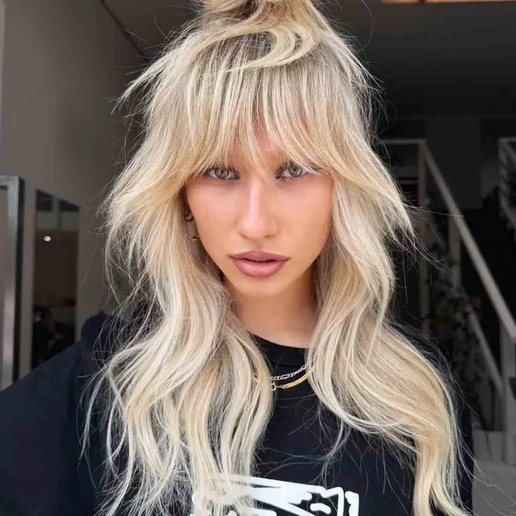 Long Shag Wolf Cut with Top Knot and Extended Bangs on Blonde Hair
