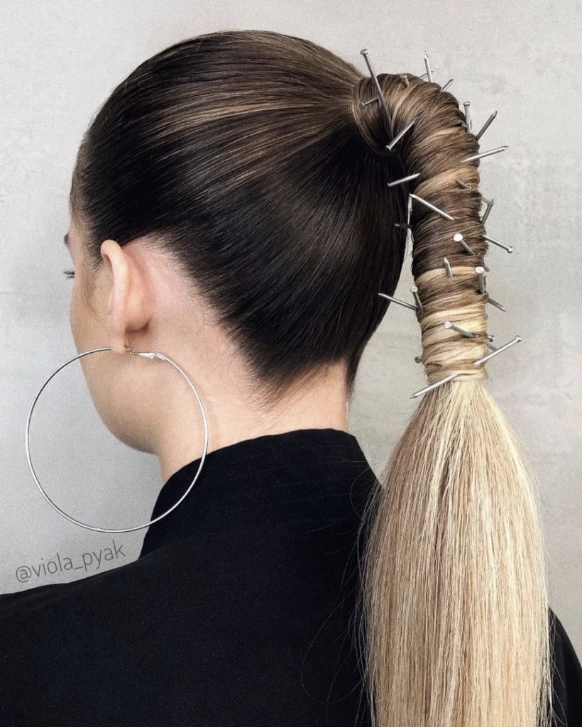 Sleek High Ponytail with Artistic Nail Embellishments