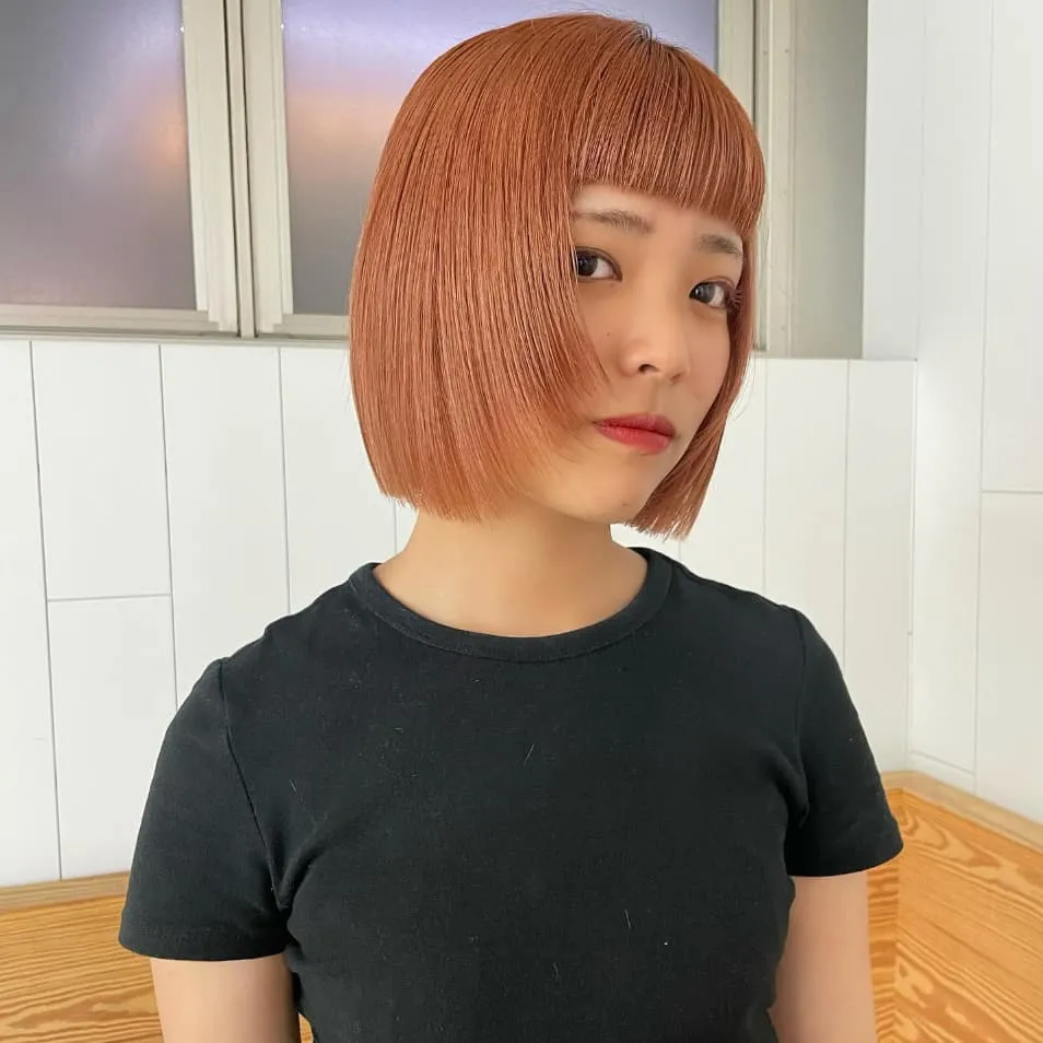 Straight Bob Wolf Cut on Ginger Hair With Blunt Bangs